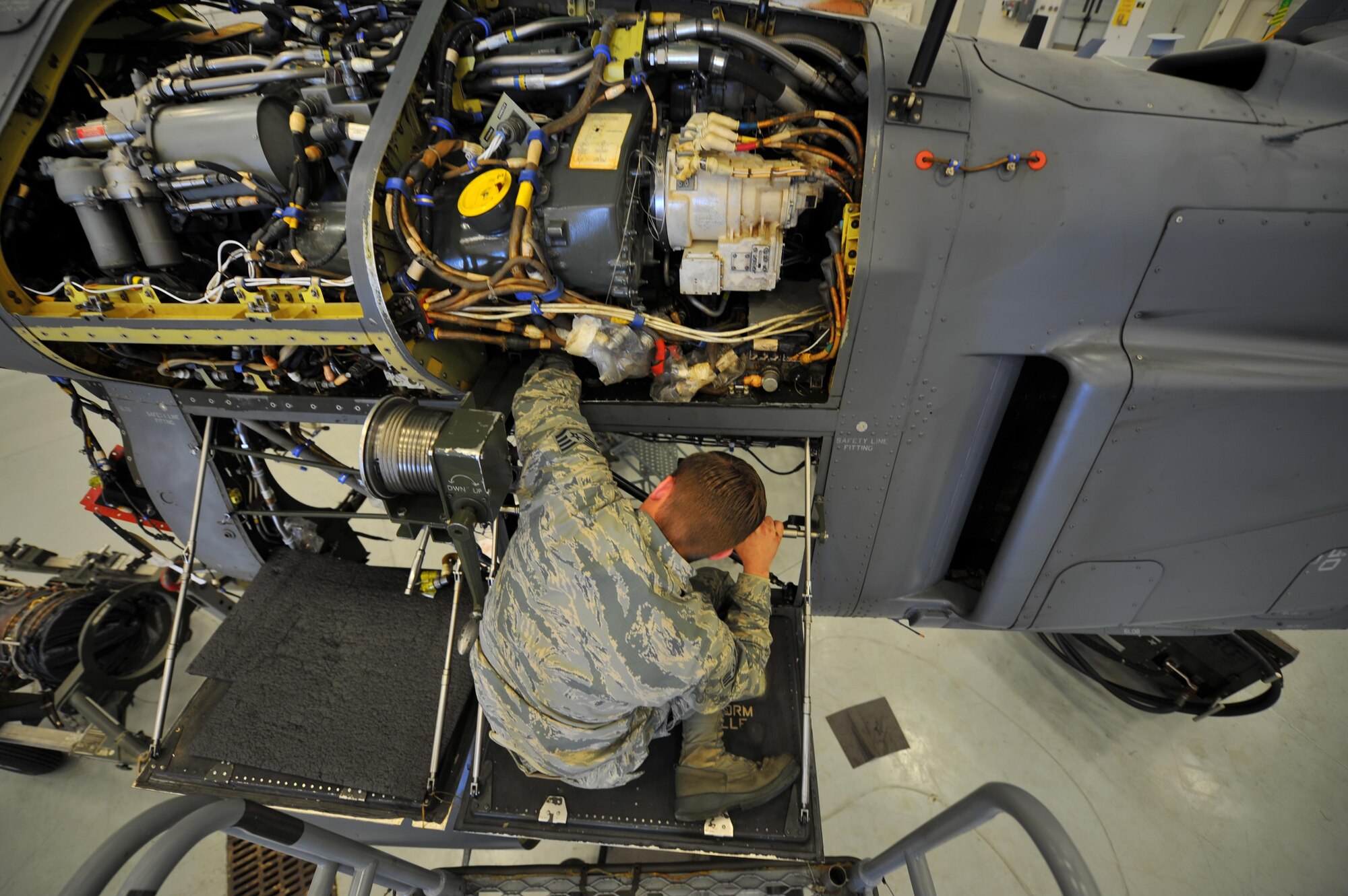 Staff Sgt. Brian Contos, a crew chief with the 801st Special Operations Aircraft Maintenance Squadron, conducts repairs on a CV-22B Osprey at Hurlburt Field, Fla., March 21, 2016. The 801st SOAMXS won the 2015 Maintenance Effectiveness Award for small aircraft maintenance unit. The Air Force MEA recognizes maintenance units who have effectively managed resources in three separate areas: mission accomplishment, innovative and effective use of maintenance resources, and personnel quality of life programs. (U.S. Air Force photo by Airman 1st Class Joseph Pick)