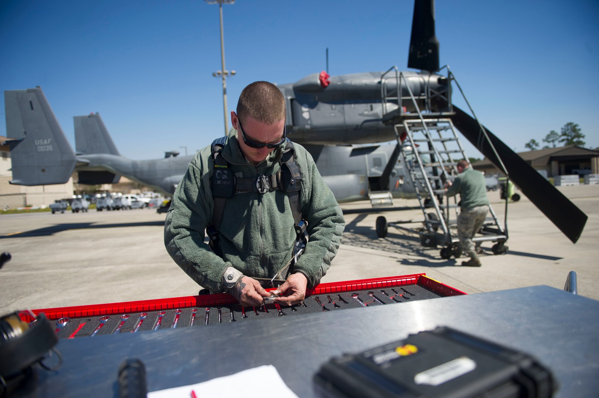 Senior Airman Jacob Anderson, a crew chief with the 801st Special Operations Aircraft Maintenance Squadron, grabs tools while working on a CV-22B Osprey hydraulic swivel at Hurlburt Field, Fla., March 21, 2016. The 801st SOAMXS supports the 8th Special Operations Support Squadron, combatant commanders, operational and developmental testing, and special operations forces. (U.S. Air Force photo by Senior Airman Krystal M. Garrett)
