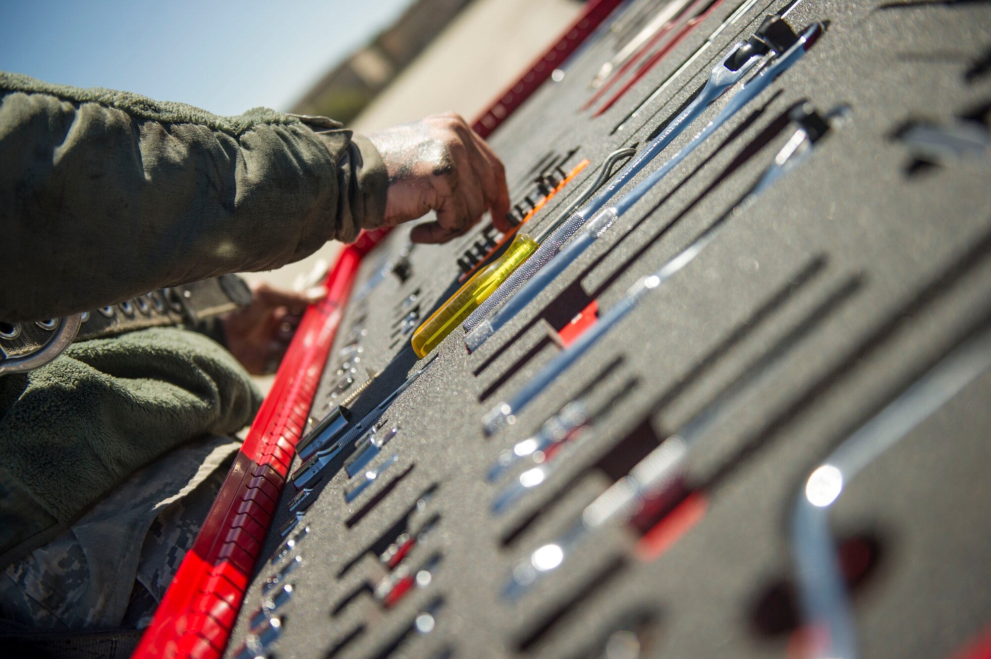 Senior Airman Jacob Anderson, a crew chief with the 801st Special Operations Aircraft Maintenance Squadron, grabs tools while working on a CV-22B Osprey hydraulic swivel at Hurlburt Field, Fla., March 21, 2016. The 801st SOAMXS won the 2015 Maintenance Effectiveness Award for small aircraft maintenance unit. The Air Force MEA recognizes maintenance units who have effectively managed resources in three separate areas: mission accomplishment, innovative and effective use of maintenance resources, and personnel quality of life programs. (U.S. Air Force photo by Senior Airman Krystal M. Garrett)