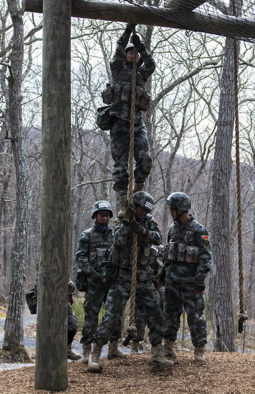 Officer Cadets from the Peoples Liberation Army University of Science and Technology in China find creative ways to complete 'the tough one' obstacle during the train-up prior to the 2016 Sandhurst competition held at the United States Military Academy at West Point, N.Y., April 6, 2016. The team from China is one of 12 international teams competiting in this year's Sandhurst event. (U.S. Army photo Sgt. 1st Class Brian Hamilton/released)