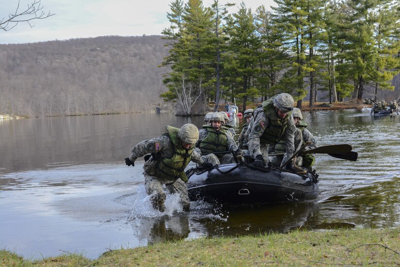 Cadets from the United States Military Academy at West Point, N.Y., hop off the front of a zodiac at the turn around point of the water crossing event during the 2016 Sandhurst competition, April 9, 2016. Competitors were required to paddle across a lake outside of Camp Buckner, grab a single piece of engineer tape, and then paddle back to the finish line.The competition originated in 1967 as a friendly match of skill and endurance between West Points Corps of Cadets and their counterparts at the Royal Military Academy Sandhurst in the United Kingdom. Overall the competition has expanded in both size and difficulty. What started as a 2-team competition in 1967 has expanded to 60 teams from 13 different countries. Each team of cadets is expected to log close to 35 miles over a 36 hour time frame with various squad level tasks thrown in along their route. (U.S. Army photo Sgt. 1st Class Brian Hamilton/released)