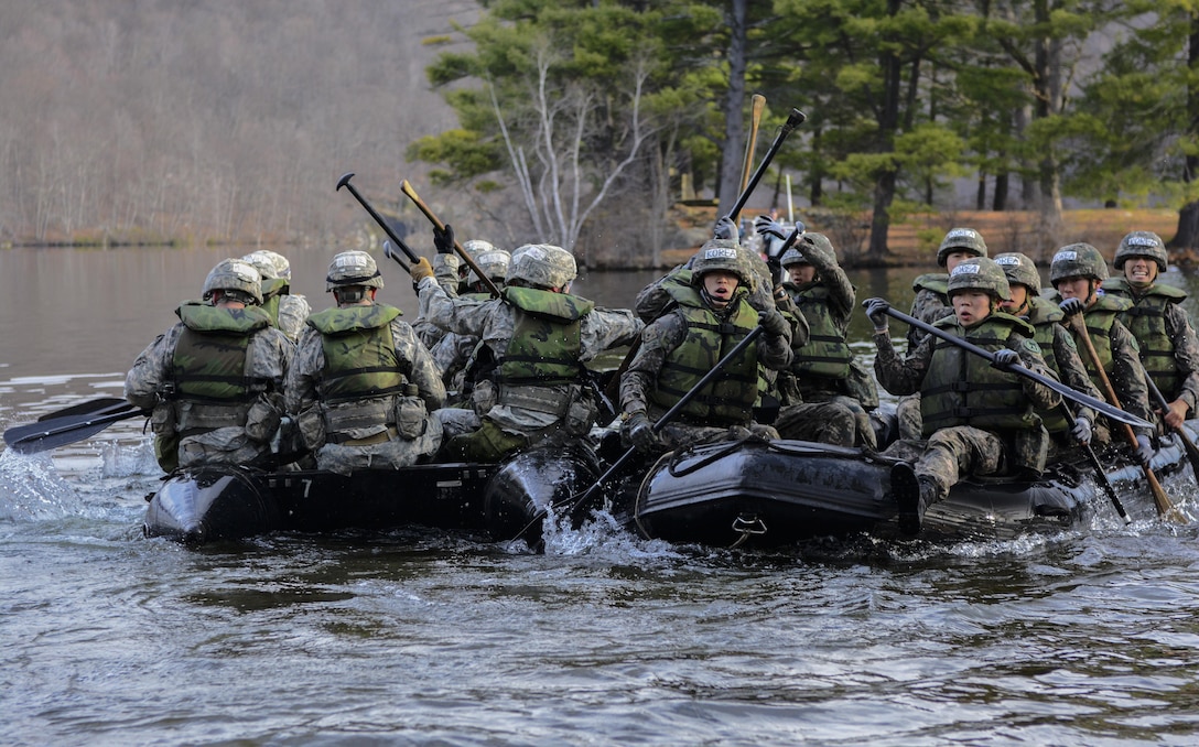 Teams of cadets pass by each other during the water crossing event at the 2016 Sandhurst competition held at West Point, N.Y., April 8-9, 2016. Cadets in this year's competition were required to paddle a zodiac inflatable boat across a lake, grab a piece of engineer tape and paddle back to the finish line. This year 60 teams from 13 different countries participated in the competition that originated between the United States Military Academy and the Royal Military Academy Sandhurst in Great Britain. (U.S. Army photo Sgt. 1st Class Brian Hamilton/released)