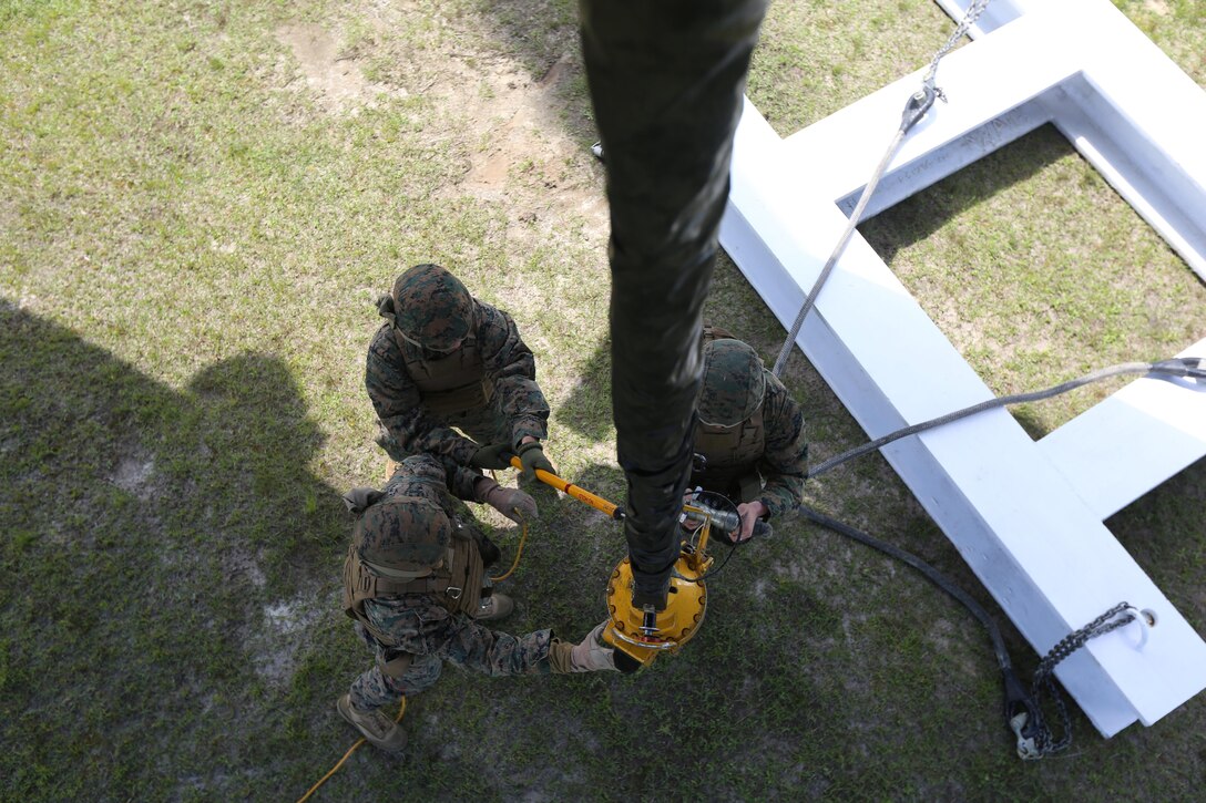 Marines with Combat Logistics Battalion 6, Transportation Support Battalion, connect cargo to a hook attached to a CH-53E Super Stallion at landing zone Phoenix, Camp Davis, North Carolina, April 6, 2016. The purpose of external lifts is to transport larger amounts of supplies and heavy gear where other ground vehicles can’t access. (U.S. Marine Corps photo by Lance Cpl. Aaron Fiala/Released.)