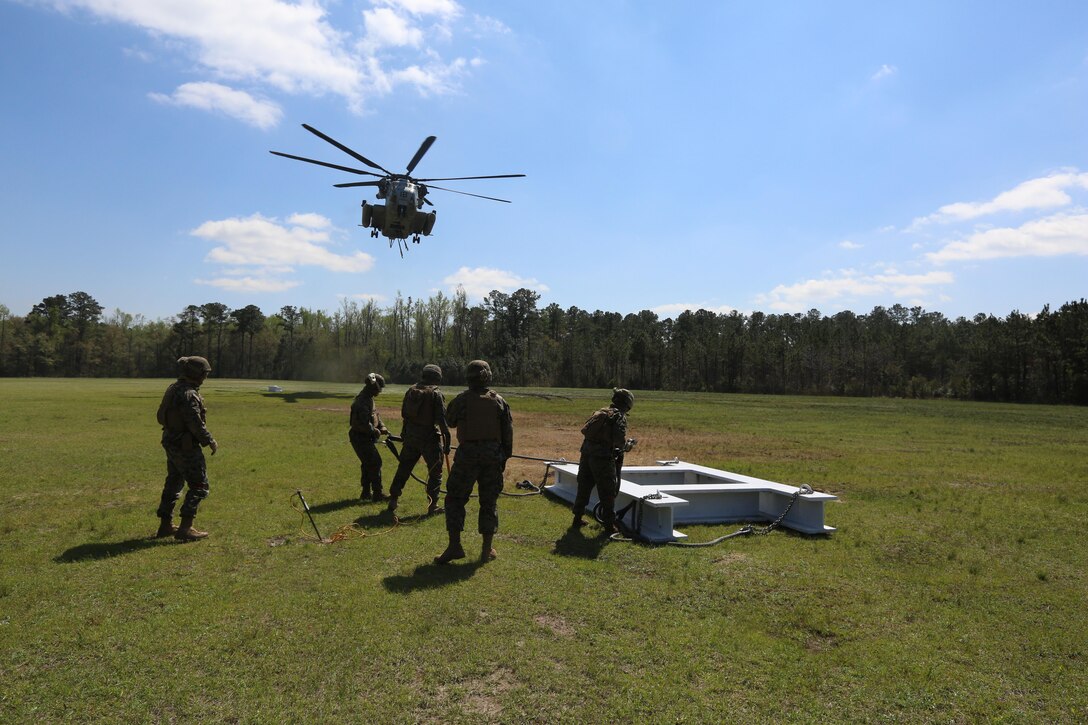 Landing support specialists with Combat Logistics Battalion 6, Transportation Support Battalion, prepare a CH-53E Super Stallion with Marine Heavy Helicopter Training Squadron 302 to extract cargo during external lifts at landing zone Phoenix, Camp Davis, North Carolina, April 6, 2016. The purpose of external lifts is to transport larger amounts of supplies and heavy gear where other ground vehicles can’t access. (U.S. Marine Corps photo by Lance Cpl. Aaron Fiala/Released.)