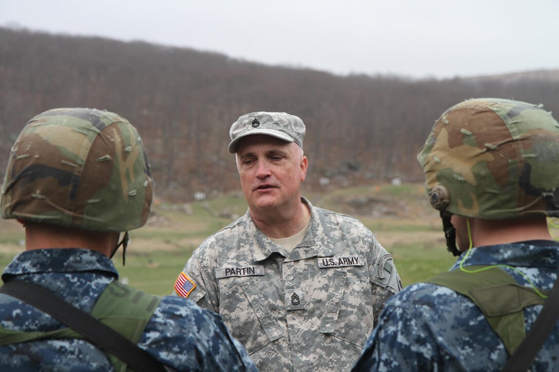 Sgt. 1st Class Jonathan Partin, of Co. A, 3rd Bn., 304th Inf. Reg. (USMA) 104th Training Div. (LT), briefs Cadets from the United States Naval Academy on range safety prior to their turn on the firing line to qualify on their M-4 carbine during the 2016 Sandhurst Competition held at the United States Military Academy at West Point, N.Y. Apr. 8-9, 2016. The Sandhurst Competition is an annual event held at the USMA where the cadets of military academies from around the world compete in a variety of Soldier skills in which Non-Commissioned Officers of Companies A and B of the 3rd Bn., 304th Inf. Reg. (USMA) both mentor and evaluate the Cadets on their performance. (U.S. Army photo by Sgt. Javier Amador/ released)