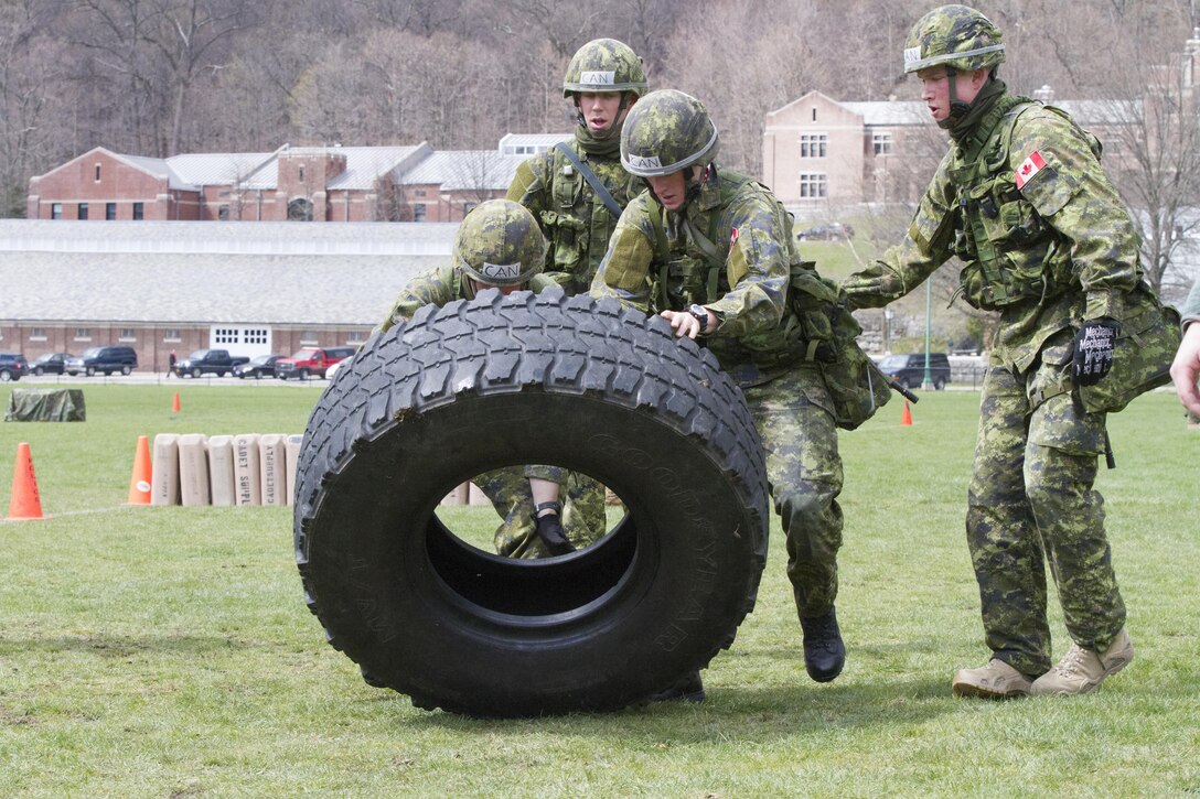 Officer Cadets of the Royal Military College of Canada exercise teamwork in moving a heavy tactical vehicle tire out and back to marked positions as quickly as they can during a series of timed events which also included carrying fellow Cadets acting as casualties as well as moving and re-stacking a pallet of Meals Ready to Eat (MREs) during the annual Sandhurst Competition held at the United States Military Academy Apr. 8-9, 2016. The Sandhurst Competition is an annual event held at the United States Military Academy (USMA) where military academies from around the world compete in a variety of Soldier skills in which Non-Commissioned Officers of Companies A and B of the 3rd Bn., 304th Inf. Reg. (USMA) both mentor and evaluate the Cadets on their performance. (U.S. Army photo by Sgt. Javier Amador) (released)