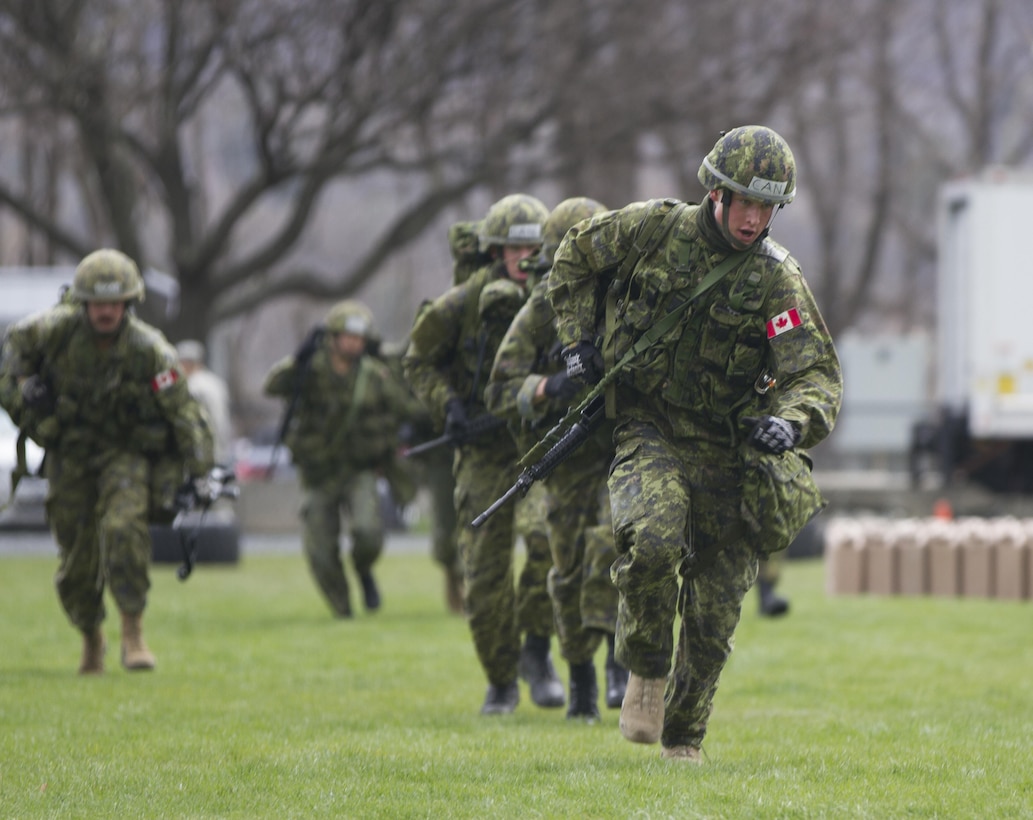 Officer Cadet Matthew Weeks, a third year student at the Royal Military College of Canada leads his fellow Cadets to the next event during the annual Sandhurst Competition held at the United States Military Academy Apr. 8-9, 2016. The Sandhurst Competition is an annual event held at the United States Military Academy (USMA) where the cadets of military academies from around the world compete in a variety of Soldier skills in which Non-Commissioned Officers of Companies A and B of the 3rd Bn., 304th Inf. Reg. (USMA) both mentor and evaluate the Cadets on their performance. (U.S. Army photo by Sgt. Javier Amador) (released)