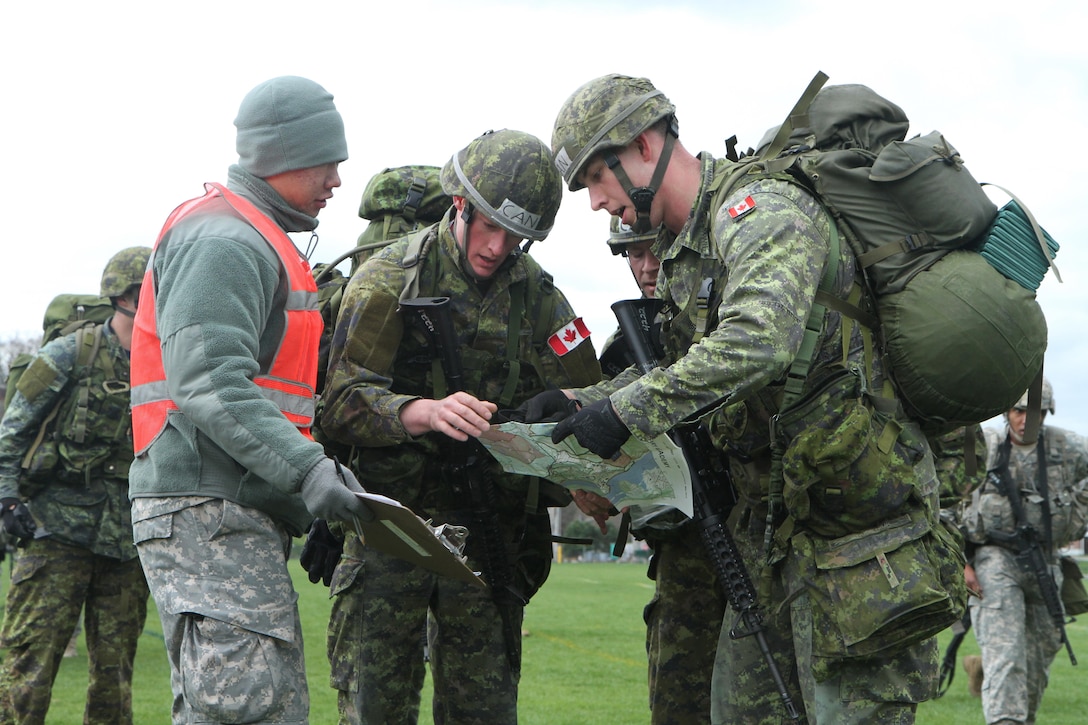 Officer Cadets of the Royal Military College of Canada brief a United States Military Academy (USMA) Cadet scorekeeper on where their next checkpoint will be during the annual Sandhurst Competition held at the United States Military Academy Apr. 8-9, 2016. The Sandhurst Competition is an annual event held at the United States Military Academy (USMA) where the cadets of  military academies from around the world compete in a variety of Soldier skills in which Non-Commissioned Officers of Companies A and B of the 3rd Bn., 304th Inf. Reg. (USMA) both mentor and evaluate the Cadets on their performance. (U.S. Army photo by Sgt. Javier Amador) (released)