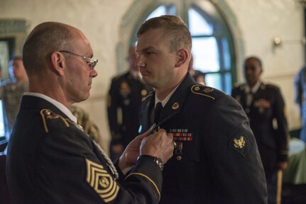 Command Sgt. Maj. Peter Running, the senior enlisted advisor for the U.S. Army Civil Affairs and Psychological Operations Command, announces the enlisted USACAPOC best warrior winner, Spc. Ian Duprey, a chaplain's assistant from Hague, Va., representing the 437th Civil Affairs Battalion at Fort Hunter Liggett, Calif., April 7, 2016. This year’s Best Warrior competition will determine the top noncommissioned officer and junior enlisted Soldier who will represent USACAPOC in the Army Reserve Best Warrior competition later this year. (U.S. Army photo by Master Sgt. Mark Burrell, 352nd CACOM)