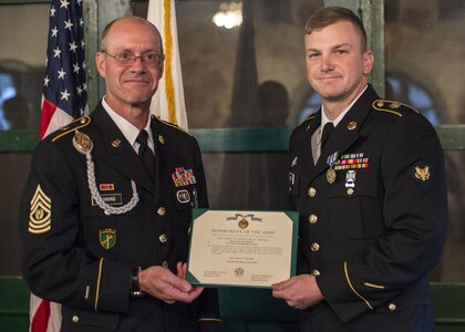 Command Sgt. Maj. Peter Running, the senior enlisted advisor for the U.S. Army Civil Affairs and Psychological Operations Command, announces the enlisted USACAPOC best warrior winner, Spc. Ian Duprey, a chaplain's assistant from Hague, Va., representing the 437th Civil Affairs Battalion at Fort Hunter Liggett, Calif., April 7, 2016. This year’s Best Warrior competition will determine the top noncommissioned officer and junior enlisted Soldier who will represent USACAPOC in the Army Reserve Best Warrior competition later this year. (U.S. Army photo by Master Sgt. Mark Burrell, 352nd CACOM)