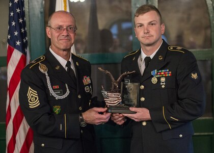 Command Sgt. Maj. Peter Running, the senior enlisted advisor for the U.S. Army Civil Affairs and Psychological Operations Command, announces the enlisted USACAPOC best warrior winner, Spc. Ian Duprey, a chaplain's assistant from Hague, Va., representing the 437th Civil Affairs Battalion at Fort Hunter Liggett, Calif., April 7, 2016. This year’s Best Warrior competition will determine the top noncommissioned officer and junior enlisted Soldier who will represent USACAPOC in the Army Reserve Best Warrior competition later this year. (U.S. Army photo by Master Sgt. Mark Burrell, 352nd CACOM)