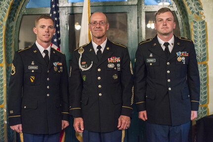 Command Sgt. Maj. Peter Running, the senior enlisted advisor for the U.S. Army Civil Affairs and Psychological Operations Command, announces the NCO and enlisted USACAPOC best warriors. Staff Sgt. Alex Herrmann, left, a civil affairs specialist from Amarillo, Texas, representing the 350th Civil Affairs Command, and Spc. Ian Duprey, right, a chaplain's assistant from Hague, Va., representing the 437th Civil Affairs Battalion at Fort Hunter Liggett, Calif., April 7, 2016. This year’s Best Warrior competition will determine the top noncommissioned officer and junior enlisted Soldier who will represent USACAPOC in the Army Reserve Best Warrior competition later this year. (U.S. Army photo by Master Sgt. Mark Burrell, 352nd CACOM)