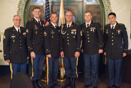 Command Sgt. Maj. Peter Running, the senior enlisted advisor for the U.S. Army Civil Affairs and Psychological Operations Command, announces the NCO and enlisted USACAPOC best warriors. Staff Sgt. Alex Herrmann, a civil affairs specialist from Amarillo, Texas, representing the 350th Civil Affairs Command, and Spc. Ian Duprey, a chaplain's assistant from Hague, Va., representing the 437th Civil Affairs Battalion at Fort Hunter Liggett, Calif., April 7, 2016. This year’s Best Warrior competition will determine the top noncommissioned officer and junior enlisted Soldier who will represent USACAPOC in the Army Reserve Best Warrior competition later this year. (U.S. Army photo by Master Sgt. Mark Burrell, 352nd CACOM)