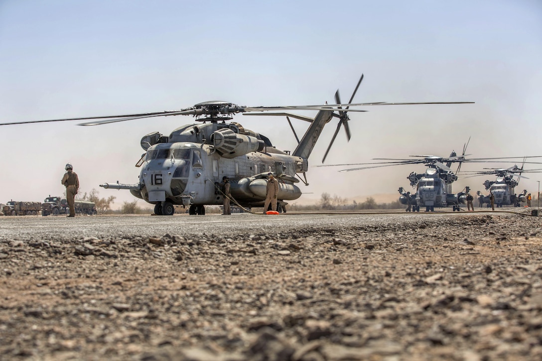 Marines refuel three CH-53E Super Stallion helicopters during Weapons and Tactics Instructor course 2-16 at landing zone bull, located in the Chocolate Mountain Aerial Gunnery Range, Arizona, March 26, 2016. Marine Corps photo by Lance Cpl. Anabel Abreu-Rodriguez