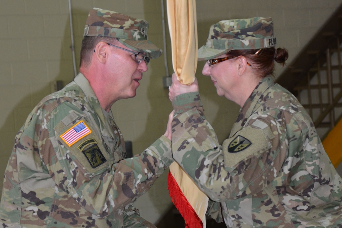 Brig. Gen. Jeffrey Doll, commander of the Army Reserve Sustainment Command, prepares to pass the unit colors to the incoming command sergeant major. As the colors are passed, Command Sgt. Maj. Kristal Florquist is entrusted with the responsibility and care of the unit Soldiers. 