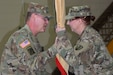 Brig. Gen. Jeffrey Doll, commander of the Army Reserve Sustainment Command, prepares to pass the unit colors to the incoming command sergeant major. As the colors are passed, Command Sgt. Maj. Kristal Florquist is entrusted with the responsibility and care of the unit Soldiers. 