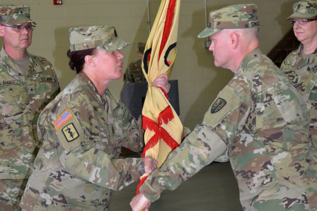 1st Sgt. Louie Singleton, Headquarters Company first sergeant with the Army Reserve Sustainment Command, passes the unit colors to Command Sgt. Maj. Vicki Briggs, outgoing command sergeant major of the ARSC. The passing of the colors symbolizes the transfer of responsibility from one leader to another. 