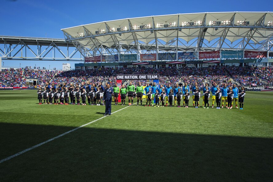 Master Sgt. Shana Wallace, of the 512th Airlift Wing, sings the national anthem before a crowd of 20-thousand fans at Talen Energy Stadium, Chester, Pa., April 10, 2016, before the US Women's Soccer team played Columbia's national soccer team. The friendly competition was the second in a month between the two teams, and the US team won both matches 7-0 and 3-0. 