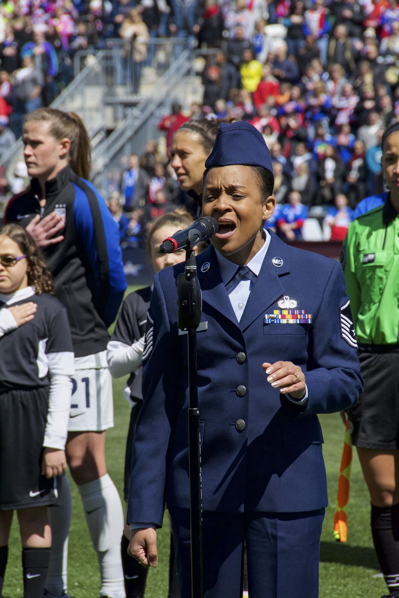 Master Sgt. Shana Wallace, of the 512th Airlift Wing, sings the national anthem before a crowd of 20-thousand fans at Talen Energy Stadium, Chester, Pa., April 10, 2016, before the US Women's Soccer team played Columbia's national soccer team. The friendly competition was the second in a month between the two teams, and the US team won both matches 7-0 and 3-0. (U.S. Air Force Photo/Tech. Sgt. Mercedes Crossland)