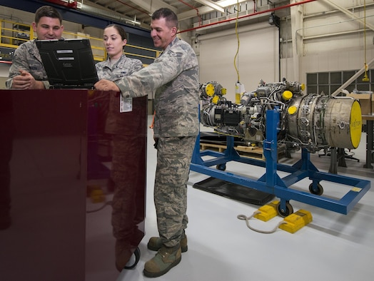 Senior Airmen Natalie Beal, Ryan Nelapa, Norman Rothchild, 919th Special Operations Maintenance Group, look over an electronic technical order used for performing maintenance on an aircraft engine at Duke Field Fla., Feb. 25.  The Airmen are part of the engine shop of the 919th Special Operations Maintenance Group.  (U.S. Air Force photo/Tech. Sgt. Sam King)
