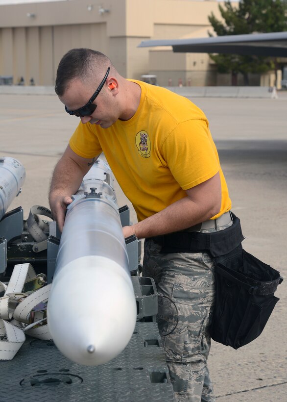 Senior Airman Kory Hickok, 56th Aircraft Maintenance Squadron weapons load crew member, inspects an AIM 9 L/M munition during a load crew competition at Luke Air Force Base, Ariz., April 8, 2016. The load crew competition is designed to encourage friendly competition among load crew members and enable them to display the high skill level at which they routinely operate. The purpose of the event is to see which team loads weapons onto their respective aircraft earning the fastest time and the fewest errors. (U.S. Air Force photo by Senior Airman Devante Williams)