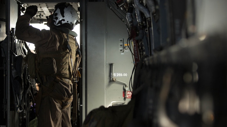 Cpl. Jesus Ontiveros, a crew chief with Marine Medium Tiltrotor Squadron (VMM) 364 “Purple Foxes,” and an Oxnard, California, native, observes a panel aboard an MV-22B Osprey during a flight above Southern California, April 5. Marines with VMM-364 and VMM-165 conducted division confined area landings to build and maintain the pilots’ and air crew’s proficiency in performing the landings. 