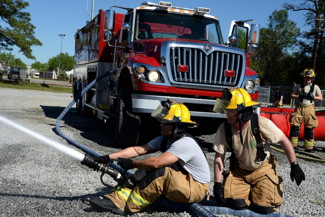 Air Force Tech. Sgt. Cesar Sauceda, left, receives instruction from Air Force Tech. Sgt. Ben Sudduth during an aircraft firefighting training exercise at the 165th Airlift Wing's Regional Fire Training Facility in Savannah, Ga., April 4th, 2016. Sauceda is assigned to the Rhode Island Air National Guard’s 143rd Airlift Wing.  Sudduth is assigned to the Vermont Air National Guard’s 158th Fighter Wing. Air National Guard photo by Tech. Sgt. Andrew J. Merlock
