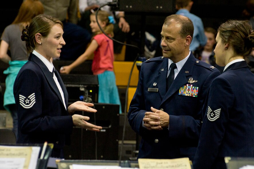 U.S. Air Force Reserve Col. Craig Drescher, commander, 913th Airlift Group, speaks with members of The United States Air Force Concert Band during an intermission at a Concert Band and Singing Sergeants performance at Little Rock Central High School, in Little Rock, Ark., Apr. 7, 2016. The Concert Band and Singing Sergeants are performing across five states during a 12-day spring tour. (U.S. Air Force photo by Master Sgt. Jeff Walston/Released)