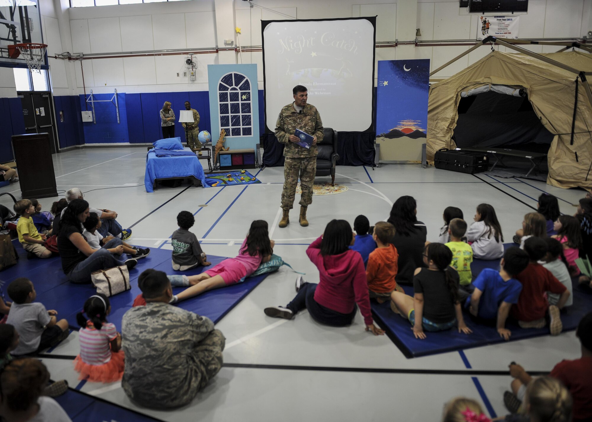 Lt. Gen. Brad Heithold, the commander of Air Force Special Operations Command, speaks to children during “Tell me a Story” at the youth center, Hurlburt Field, Fla., April 8, 2016. Heithold read “Night Catch” by Brenda Ehrmantraut. (U.S. Air Force photo by Senior Airman Meagan Schutter)