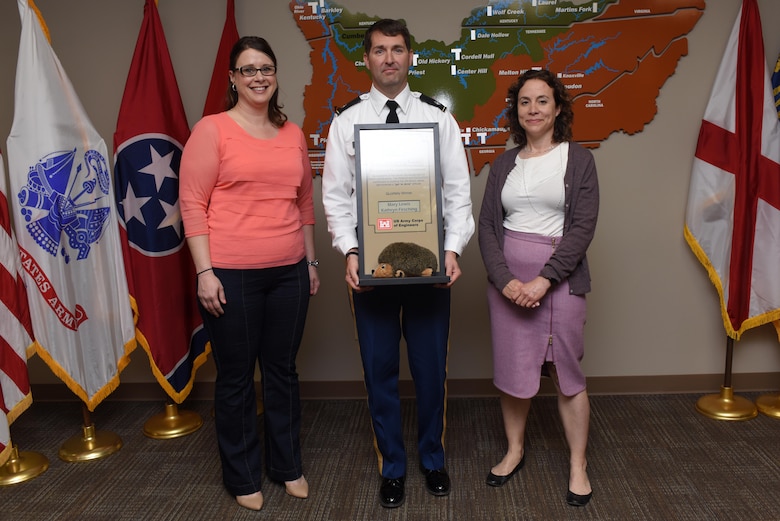 Lt. Col. Stephen Murphy, U.S. Army Corps of Engineers Nashville District commander, presents the Hedgehog Award to Kathryn Firsching (Right), assistant district counsel, and Mary Lewis, interagency coordinator, at the district headquarters in Nashville, Tenn., April 8, 2016. The award is given quarterly by the Nashville District to individuals or team of employees to recognize excellence.  The dynamic duo reduced the time it takes to process interagency and international services and Economy Act agreements with other federal, state and local stakeholders from three months to only one. (USACE photo by Leon Roberts)