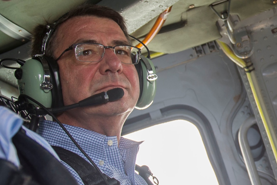 Defense Secretary Ash Carter listens to radio traffic aboard a U.S. Navy helicopter as he travels to the Karwar naval base in India, April 11, 2016. DoD photo by Air Force Senior Master Sgt. Adrian Cadiz