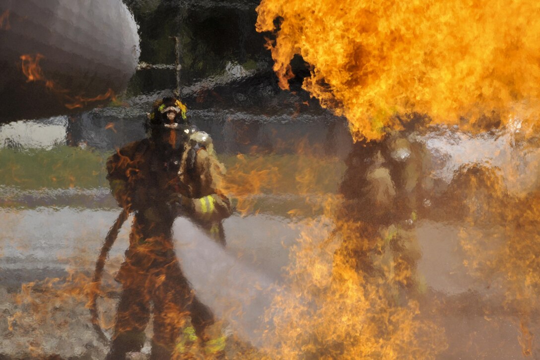 An Air National Guard firefighter participates in an aircraft fire training exercise at the 165th Airlift Wing's Regional Fire Training Facility in Savannah, Ga., April 4, 2016. Air National Guardsmen from Connecticut, Maine, New Jersey, Rhode Island and Vermont participated in the training. New Jersey National Guard photo by Air Force Tech. Sgt. Andrew J. Merlock