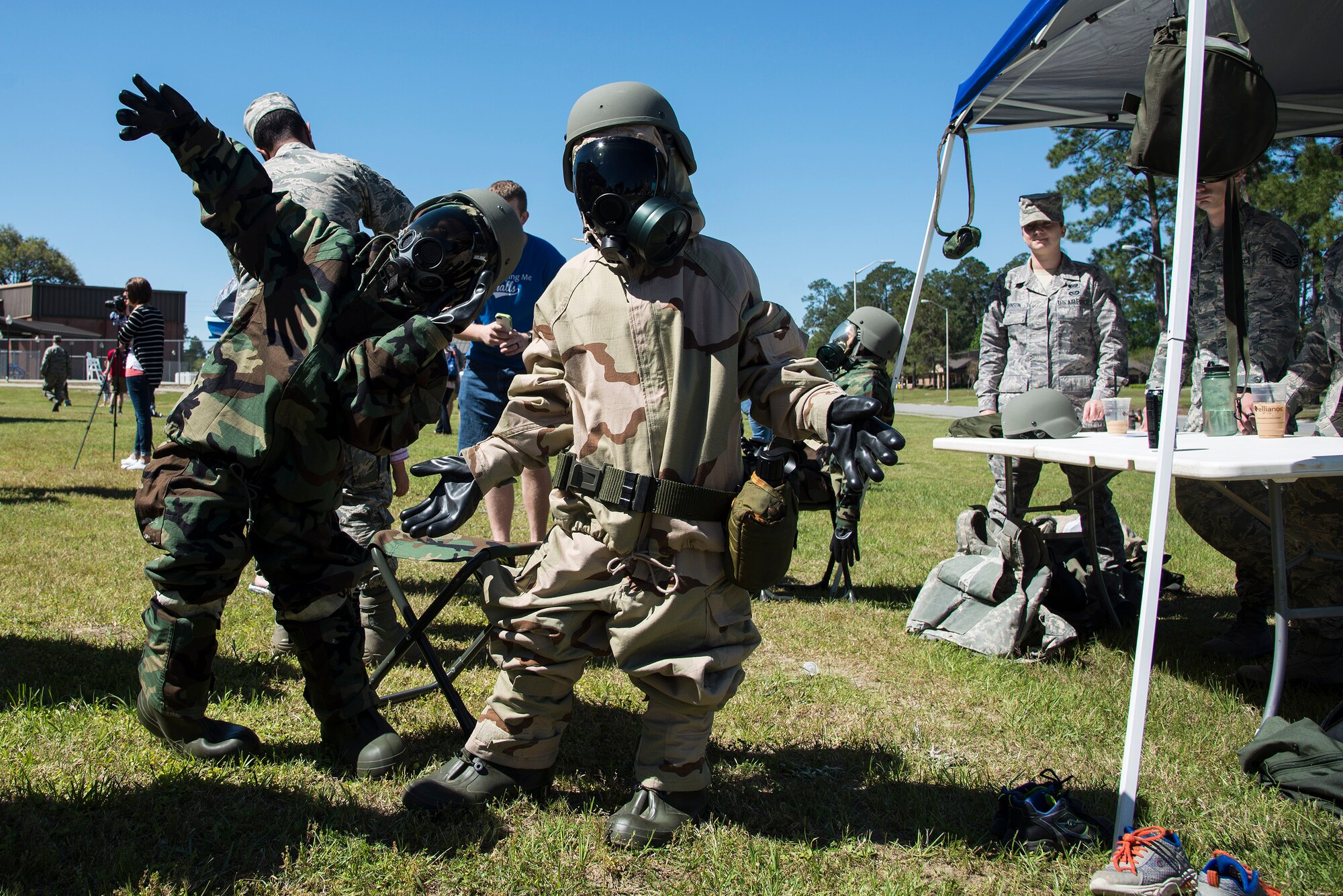 Caleb and Aiden Campbell, sons of U.S. Air Force Tech. Sgt. Lee Campbell, 23d Equipment Maintenance Squadron crew chief, pose for a photo after donning full mission-oriented protective posture gear during a kids’ deployment line, April 9, 2016, at Moody Air Force Base, Ga. MOPP gear is used to protect military personnel in the event of chemical or biological attack. (U.S. Air Force photo by Airman 1st Class Janiqua P. Robinson/Released)