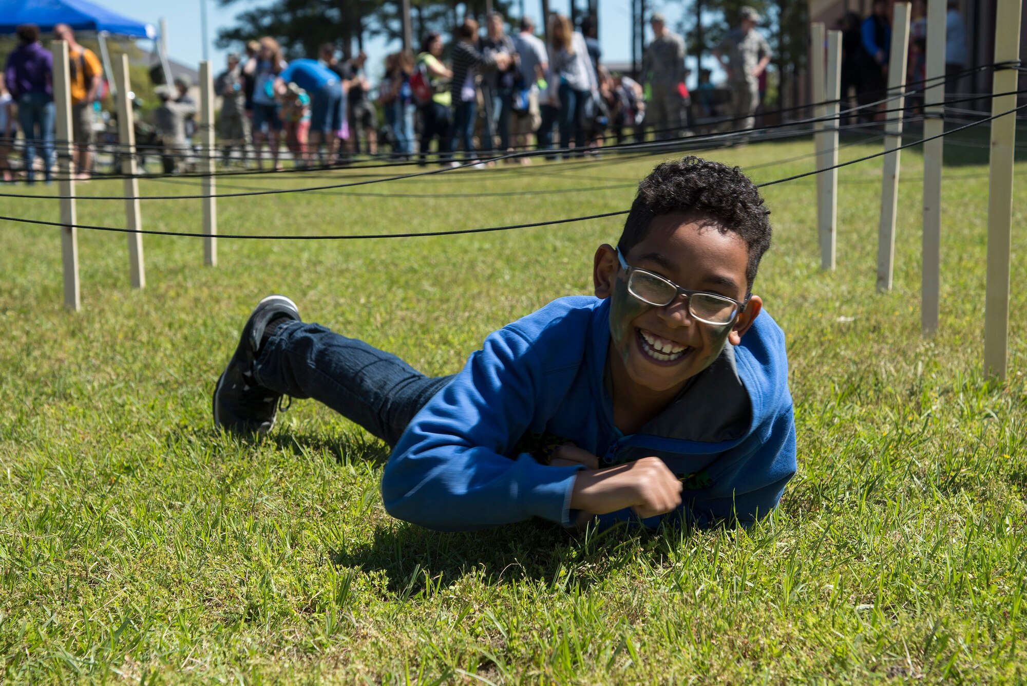 Jaydin Mota, son of U.S. Air Force Airman 1st Class Janiqua Robinson, 23d Wing Public Affairs photojournalist, crawls through an obstacle during a kids’ deployment line, April 9, 2016, at Moody Air Force Base, Ga. In addition to testing physical fitness, volunteers also provided a water station to ensure children maintained hydration. (U.S. Air Force photo by Airman 1st Class Janiqua P. Robinson/Released)