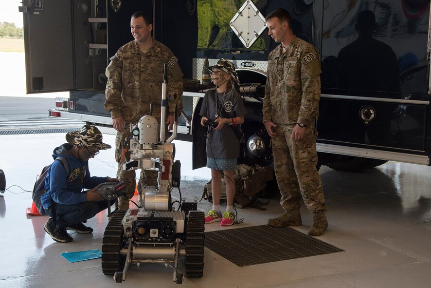 Sammie Deines, daughter of U.S. Air Force Senior Master Sgt. Kevin Akers, 822d Base Defense Squadron operations superintendent, controls a robot during a kids’ deployment line, April 9, 2016, at Moody Air Force Base, Ga. The Explosive Ordinance Disposal team displayed several robots they use to defeat improvised explosive devices. (U.S. Air Force photo by Airman 1st Class Janiqua P. Robinson/Released)