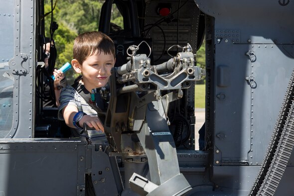 Aidan Price, son of U.S. Air Force Tech. Sgt. Matthew Price, 23d Component Maintenance Squadron section chief, aims the weapon mount on the side of an HH-60G Pave Hawk helicopter during a kids’ deployment line, April 9, 2016, at Moody Air Force Base, Ga. The event had several static displays for children to explore, including the helicopter, an A-10 Thunderbolt II and a firetruck. (U.S. Air Force photo by Airman 1st Class Janiqua P. Robinson/Released)