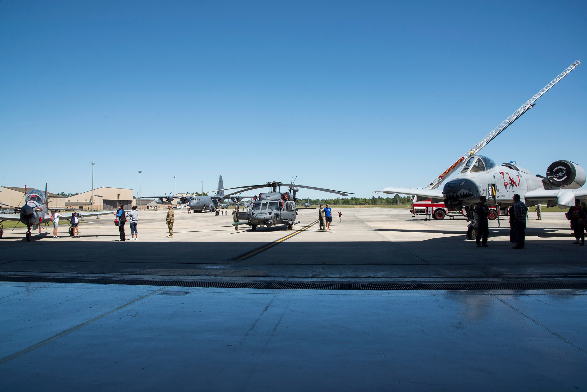 Multiple aircraft and fire trucks rest outside of a hangar during a kids’ deployment line, April 9, 2016, at Moody Air Force Base, Ga. Children climbed inside several static displays to learn more about them. (U.S. Air Force photo by Airman 1st Class Janiqua P. Robinson/Released)