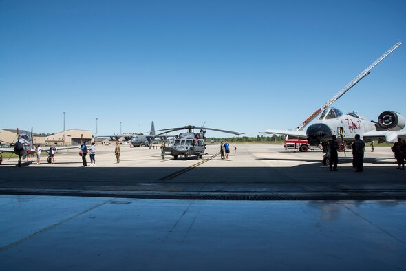 Multiple aircraft and fire trucks rest outside of a hangar during a kids’ deployment line, April 9, 2016, at Moody Air Force Base, Ga. Children climbed inside several static displays to learn more about them. (U.S. Air Force photo by Airman 1st Class Janiqua P. Robinson/Released)