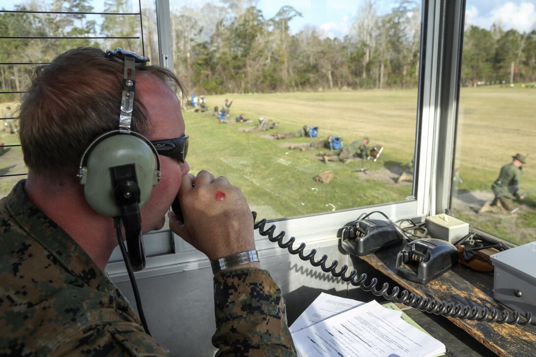 Cpl. Garan Williams, Alpha Range tower noncommissioned officer, gives commands to shooters at the 300-yard line during the Eastern Division Shooting Matches at Stone Bay Rifle Range on Marine Corps Base Camp Lejeune March 24. During the 10-day competition, shooters compete to earn individual shooting medals and team trophies while improving on the fundamentals of marksmanship with the M16A4 and M4 service rifles and M9 service pistol. (U.S. Marine Corps photo by Cpl. Mark Watola /released)