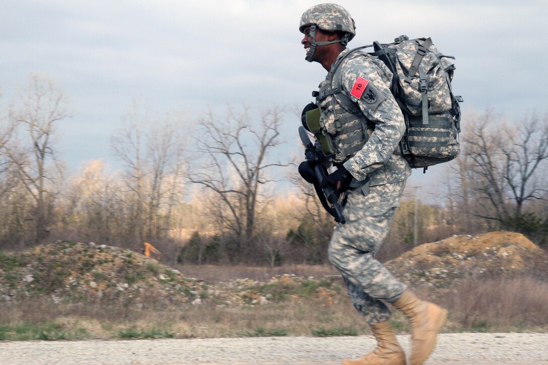 U.S. Army Reserve Spc. Jason McCord, 2nd Battalion, 58th Aviation Regiment, 11th Theater Aviation Command, takes off on a sprint during the Ruck March event of the 2016 Joint Best Warrior Competition on Fort Knox, Kentucky, March 23. 2016. (U.S. Army Photo by Clinton Wood/Released)