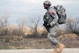 U.S. Army Reserve Spc. Jason McCord, 2nd Battalion, 58th Aviation Regiment, 11th Theater Aviation Command, takes off on a sprint during the Ruck March event of the 2016 Joint Best Warrior Competition on Fort Knox, Kentucky, March 23. 2016. (U.S. Army Photo by Clinton Wood/Released)