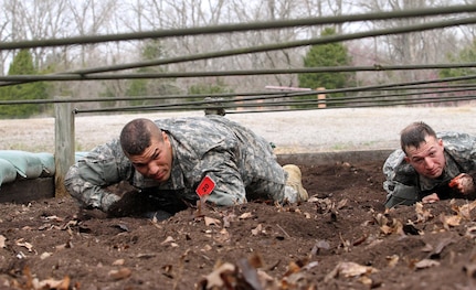 U.S. Army Reserve Staff Sgt. Joseph Mojica, 78th Training Division, 84th Training Command, left, and Sgt. Jordan Sapp, 2nd Battalion, 58th Aviation Operations, 11th Theater Aviation Command, low crawl during the the obstacle course event  of the 2016 Joint Best Warrior Competition on Fort Knox, Kentucky, March 23, 2016. (U.S. Army Photo by Clinton Wood/Released)