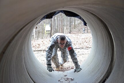 U.S. Army Reserve Spc. Steven McEown, 2nd Battalion, 311th Regiment, 78th Training Division, 84th Training Command (TC), crawls through a tunnel of the Beaudoin Obstacle Course during the 2016 Joint Best Warrior Competition on Fort Knox, Kentucky, March 23, 2016. (U.S. Army Photo by Clinton Wood/Released)