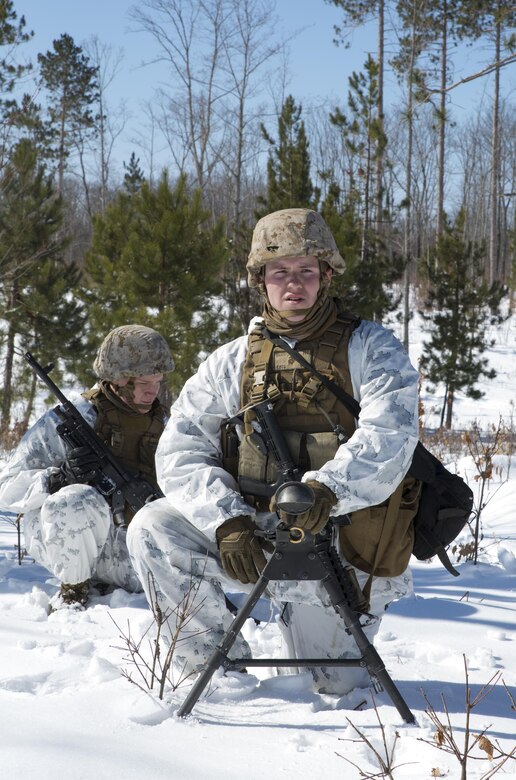 Lance Cpl. Denver J. Elliot (right) and Pfc. John O. Thompson (left), machine gunners with Weapons Platoon, Company I, 3rd Battalion, 25th Marine Regiment, 4th Marine Division, Marine Forces Reserve, standby for orders at the infantry squad battle course during exercise Arctic Eagle at Camp Grayling, Mich., April 5, 2016. The Marines joined soldiers with the U.S. Army National Guard and the Danish Home Guard in the bilateral exercise, designed to simulate a joint task force defending key infrastructure in the arctic region. (U.S. Marine Corps photo by Cpl. Ian Leones/Released)