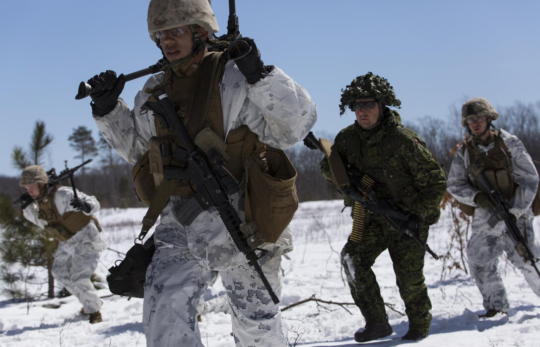 Marines with Company I, 3rd Battalion, 25th Marine Regiment, 4th Marine Division, Marine Forces Reserve, rush toward an objective at the infantry squad battle course during exercise Arctic Eagle at Camp Grayling, Mich., April 5, 2016. The Marines joined soldiers with the U.S. Army National Guard and the Danish Home Guard in the bilateral exercise, designed to simulate a joint task force defending key infrastructure in the arctic region. (U.S. Marine Corps photo by Cpl. Ian Leones/Released)
