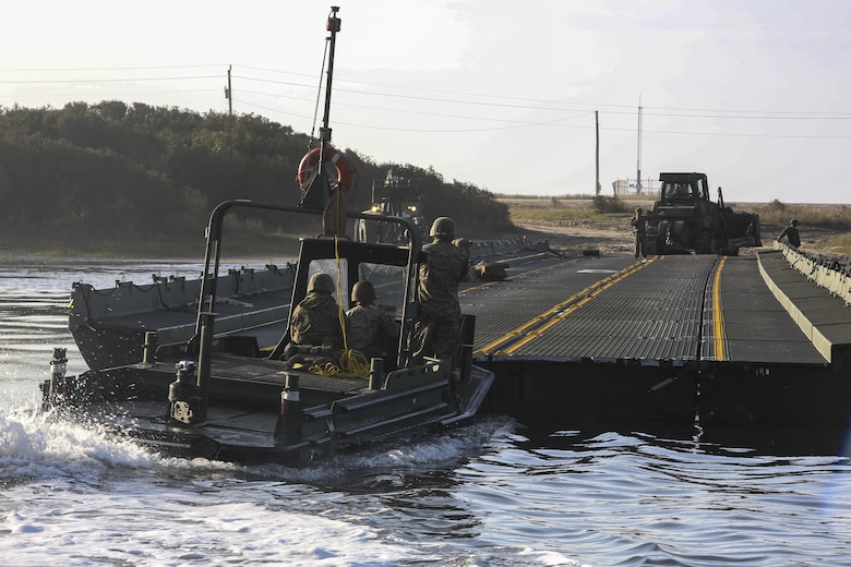 Marines with Bridge Company, 8th Engineer Support Battalion utilize a bridge erection boat to steady a bridge as part of exercise Saipan Rain at Camp Lejeune, N.C., March 30, 2016. The Marines constructed the bridge to allow Marines, vehicles, and equipment, with 10th and 14th Marine Regiments to conduct a water gap crossing. (U.S. Marine Corps photo by Cpl. Paul S. Martinez/Released)