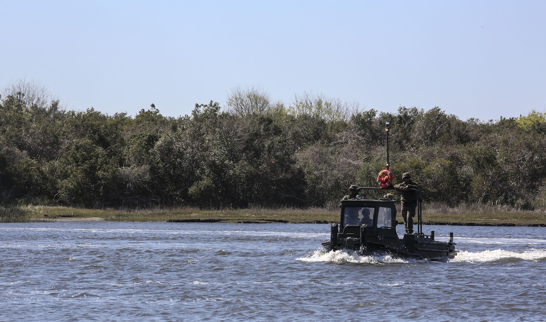 Marines with Bridge Company, 8th Engineer Support Battalion drive a bridge erection boat during the set-up of a water-crossing bridge as part of exercise Saipan Rain at Camp Lejeune, N.C., March 30, 2016. The company’s capability to construct a bridge over a body of water allows Marines and vehicles to travel to destinations that may otherwise be unreachable. (U.S. Marine Corps photo by Cpl. Paul S. Martinez/Released)