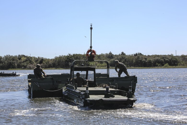 Marines with Bridge Company, 8th Engineer Support Battalion utilize a bridge erection boat to move a water bay during the set-up of a water-crossing bridge as part of exercise Saipan Rain at Camp Lejeune, N.C., March 30, 2016. The company’s capability to construct a bridge over a body of water allows Marines and vehicles to travel to destinations that may otherwise be unreachable. (U.S. Marine Corps photo by Cpl. Paul S. Martinez/Released)