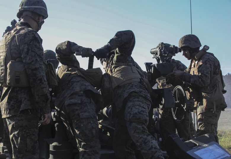 Marines with, 3rd Battalion, 14th Marine Regiment load an artillery round into an M777A2 Howitzer as part of exercise Saipan Rain at Camp Lejeune, N.C., March 30, 2016. The battery, based out of Navy Operational Support Center, Richmond, Va., joined forces with 10th Marine Regiment to support operations during the exercise. (U.S. Marine Corps photo by Cpl. Paul S. Martinez/Released)