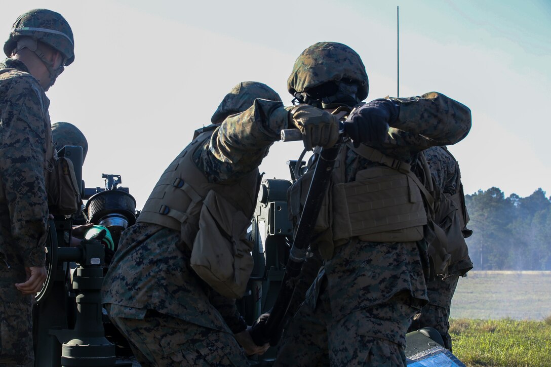Marines with 3rd Battalion, 14th Marine Regiment load an artillery round into an M777A2 Howitzer as part of exercise Saipan Rain at Camp Lejeune, N.C., March 30, 2016. The battery, based out of Navy Operational Support Center, Richmond, Va., joined forces with 10th Marine Regiment to support operations during the exercise. (U.S. Marine Corps photo by Cpl. Paul S. Martinez/Released)